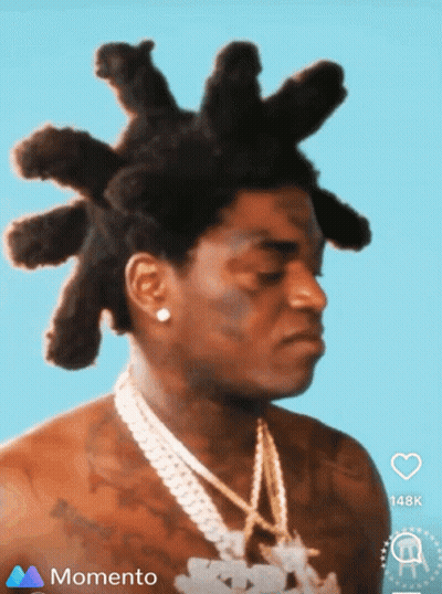 A Man With Dreadlocks And A Chain Around His Neck Is On A Momento Screen GIF