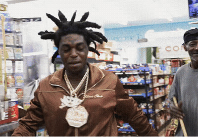 A Man With Dreadlocks And A Necklace That Says $ 100,000 On It GIF