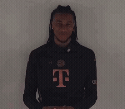 A Man With Dreadlocks And A T-Mobile Shirt Is Laughing GIF