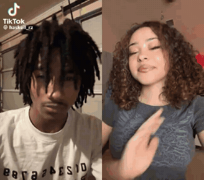 A Man With Dreadlocks And A Woman With Curly Hair Are Dancing Together On Tiktok . GIF