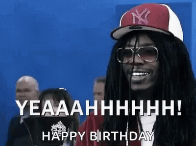 A Man With Dreadlocks And Glasses Is Wearing A Hat And Sunglasses And Saying Happy Birthday . GIF