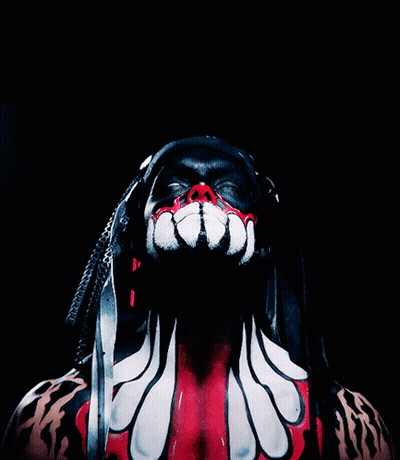 A Man With Dreadlocks And Red And White Paint On His Body GIF