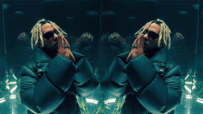 A Man With Dreadlocks And Sunglasses Is Standing In Front Of A Mirror GIF
