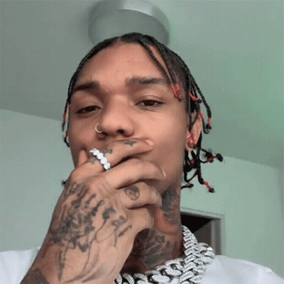 A Man With Dreadlocks Has A Ring In His Nose GIF