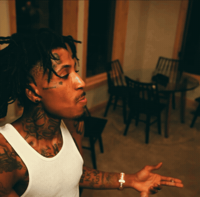 A Man With Dreadlocks Has A Tattoo On His Forehead That Says Happiness GIF