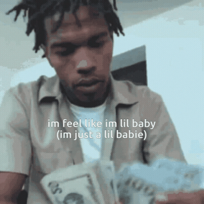 A Man With Dreadlocks Is Holding A Bunch Of Money And Says Im Feel Like Im Lil Baby GIF