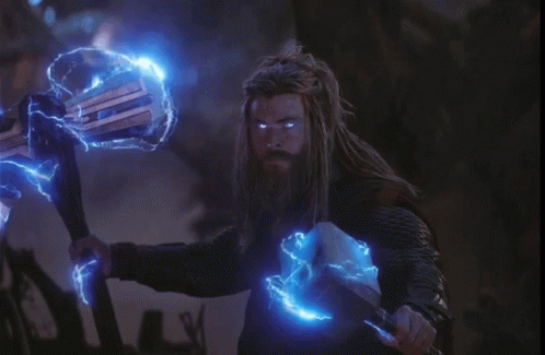 A Man With Dreadlocks Is Holding A Hammer With Blue Lightning Around It GIF