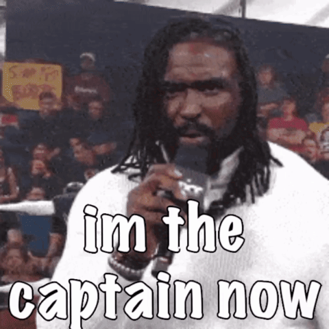 A Man With Dreadlocks Is Holding A Microphone And Says " I 'M The Captain Now " GIF