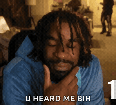 A Man With Dreadlocks Is Holding His Hand To His Chin And Says U Heard Me Buh . GIF