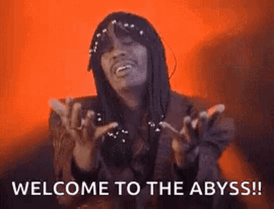 A Man With Dreadlocks Is Making A Funny Face And Saying Welcome To The Abyss . GIF