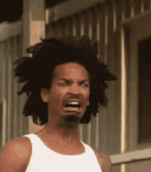 A Man With Dreadlocks Is Making A Funny Face . GIF