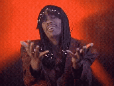 A Man With Dreadlocks Is Making A Funny Face With His Hands Outstretched . GIF