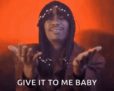 A Man With Dreadlocks Is Making A Gesture With His Hands And Saying `` Give It To Me Baby '' . GIF