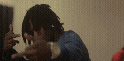 A Man With Dreadlocks Is Making A Peace Sign With His Hands GIF