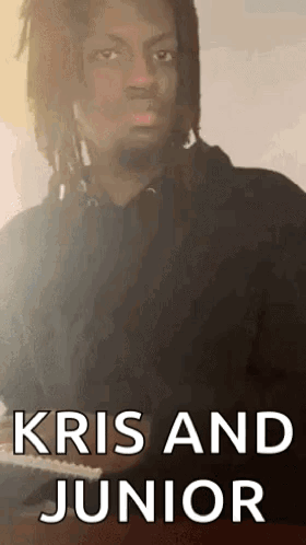 A Man With Dreadlocks Is Playing A Piano And The Words Kris And Junior Are On The Bottom Of The Image . GIF