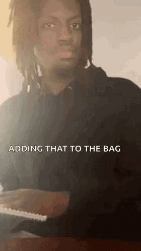 A Man With Dreadlocks Is Playing A Piano With The Words `` Adding That To The Bag '' Above Him . GIF