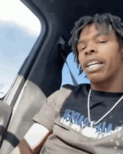 A Man With Dreadlocks Is Sitting In A Car Wearing A T-Shirt That Says ' Ecstasy ' GIF