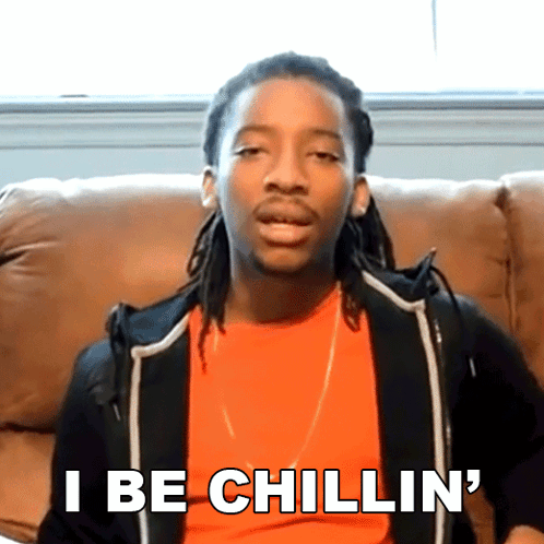 A Man With Dreadlocks Is Sitting On A Couch And Says " I Be Chillin ' " GIF