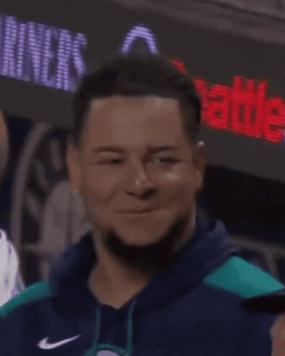 A Man With Dreadlocks Is Smiling And Wearing A Blue Sweatshirt GIF