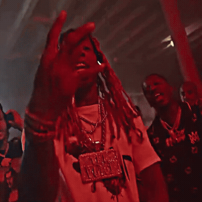 A Man With Dreadlocks Is Standing In A Dark Room . GIF