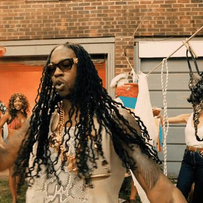 A Man With Dreadlocks Is Standing In Front Of A Clothes Line GIF