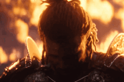 A Man With Dreadlocks Is Standing In Front Of A Flame GIF
