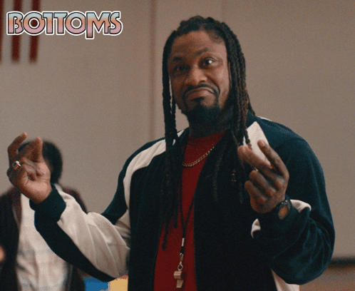 A Man With Dreadlocks Is Standing In Front Of A Poster That Says Bottoms GIF