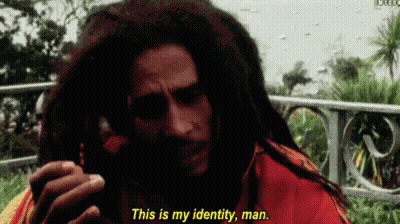 A Man With Dreadlocks Is Talking On A Cell Phone And Says " This Is My Identity Man " GIF