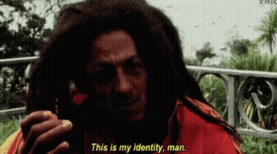 A Man With Dreadlocks Is Talking On A Cell Phone And Says " This Is My Identity Man " GIF
