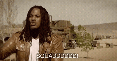 A Man With Dreadlocks Is Wearing A Brown Leather Jacket And Standing In The Desert . GIF