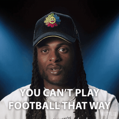 A Man With Dreadlocks Is Wearing A Hat That Says You Can 'T Play Football That Way GIF