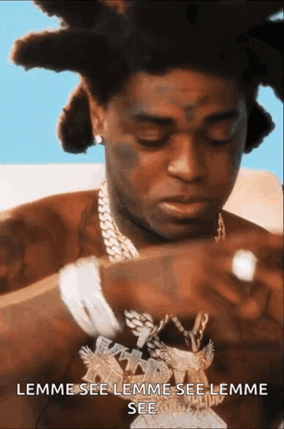 A Man With Dreadlocks Is Wearing A Necklace That Says Lemme See Lemme See Lemme See .. GIF