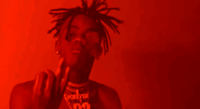 A Man With Dreadlocks Is Wearing A Necklace With The Number 99 GIF
