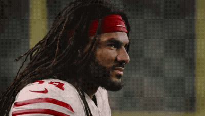 A Man With Dreadlocks Is Wearing A Nike Headband And A 49Ers Jersey GIF