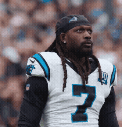 A Man With Dreadlocks Is Wearing A Number 7 Jersey And A Headband . GIF