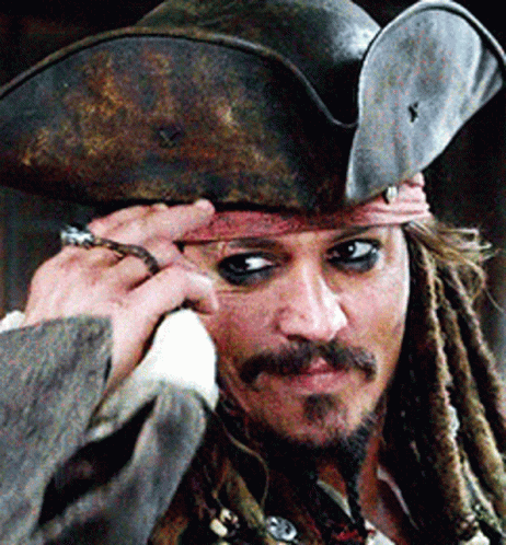 A Man With Dreadlocks Is Wearing A Pirate Hat And A Ring On His Finger GIF