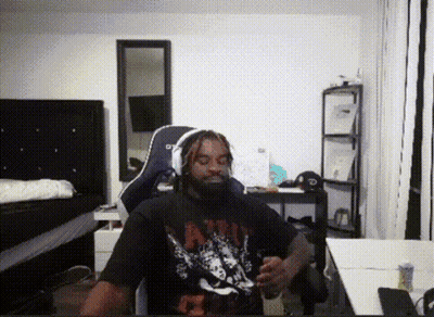 A Man With Dreadlocks Is Wearing A Shirt That Says ' Nirvana ' GIF