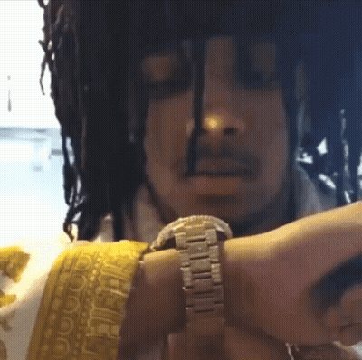 A Man With Dreadlocks Is Wearing A Watch On His Wrist GIF
