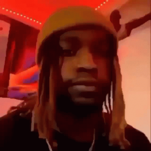 A Man With Dreadlocks Is Wearing A Yellow Hat And Earphones . GIF