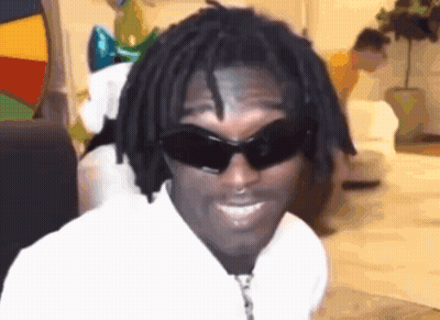 A Man With Dreadlocks Is Wearing Sunglasses And A White Shirt . GIF