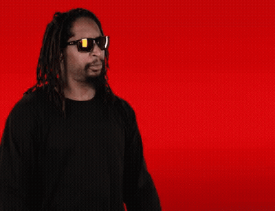 A Man With Dreadlocks Is Wearing Sunglasses And Making A Face GIF