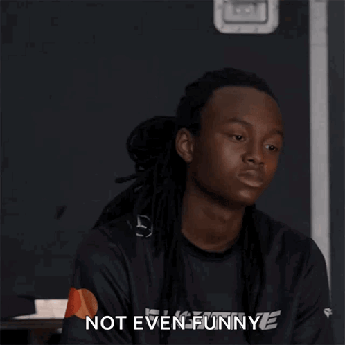 A Man With Dreadlocks Says Not Even Funny In A Black Shirt GIF