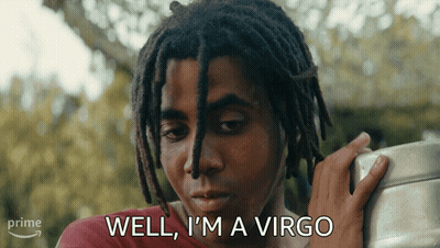 A Man With Dreadlocks Says Well I 'M A Virgo While Holding Something GIF
