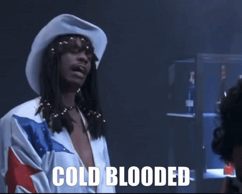 A Man With Dreadlocks Wearing A Cowboy Hat And A Shirt That Says Cold Blooded GIF