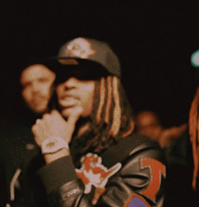 A Man With Dreadlocks Wearing A Hat And A Jacket With The Number 3 On It GIF