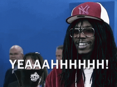 A Man With Dreadlocks Wearing A Ny Hat And Sunglasses Is Smiling And Says Yeaaahhhh ! GIF