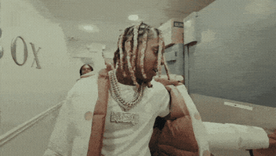 A Man With Dreadlocks Wearing A Shirt That Says Neo GIF