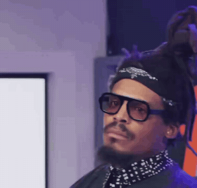 A Man With Dreadlocks Wearing Sunglasses And A Bandana GIF