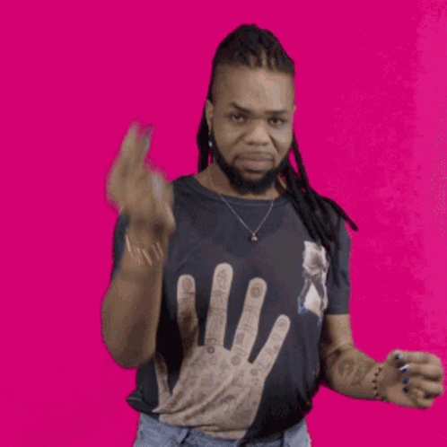 A Man With Dreadlocks Wears A Black Shirt With A Hand On It GIF