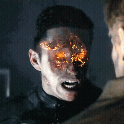 A Man With Flames Coming Out Of His Face Is Talking To Another Man GIF